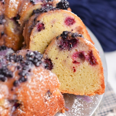 Sliced blackberry bundt cake showing tender crumb and baked blackberries