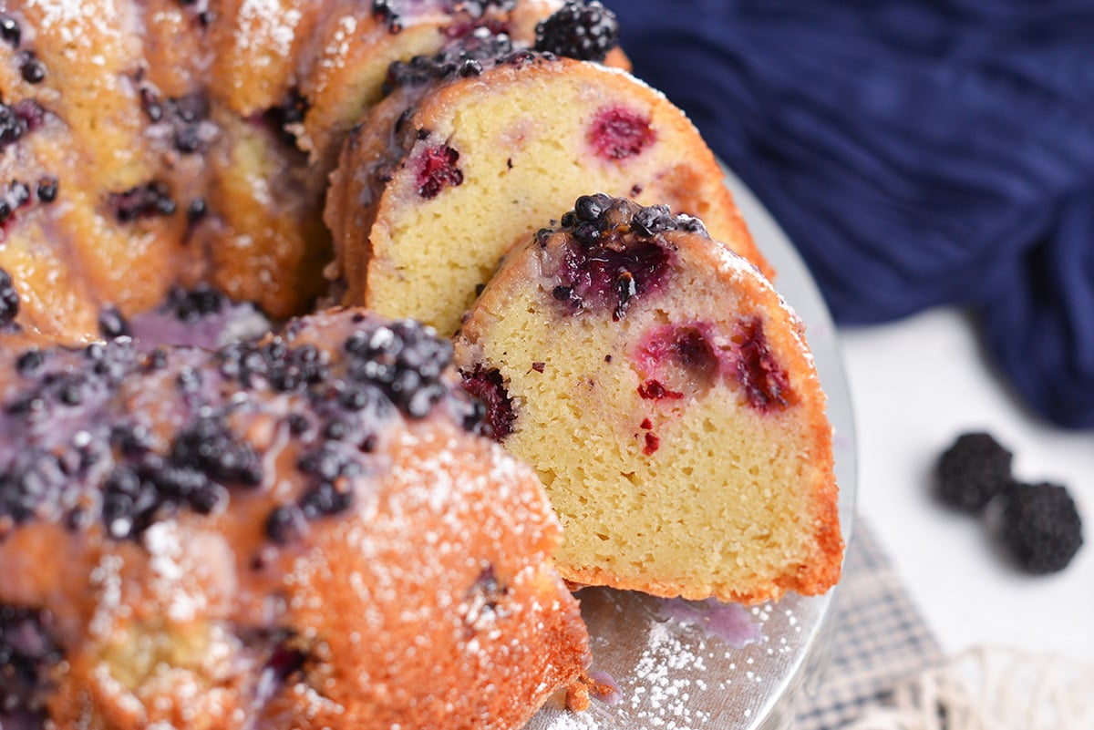Sliced blackberry bundt cake showing tender crumb and baked blackberries