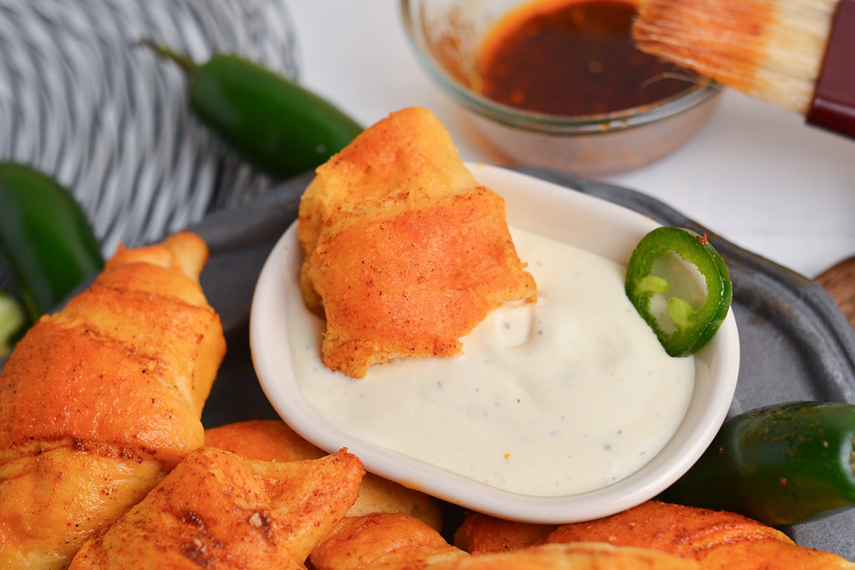 Baked jalape&ntilde;o popper puff dipped in ranch dressing