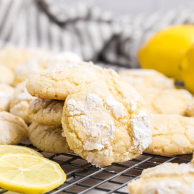 close up angled shot of lemon crinkle cookies on cooling rack