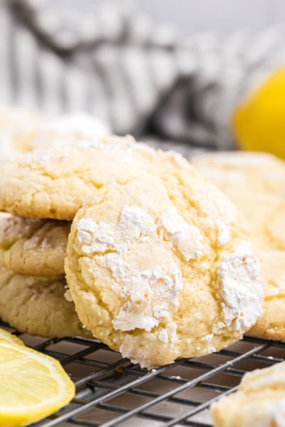 close up angled shot of lemon crinkle cookies on cooling rack