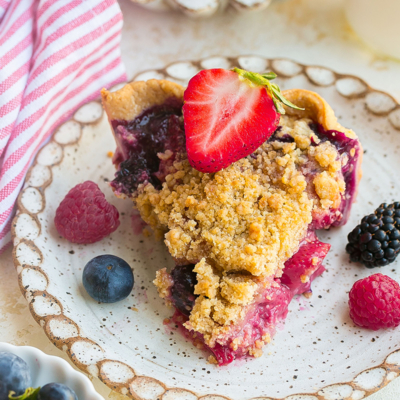 slice of pie on plate topped with strawberry