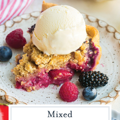 angled shot of slice of mixed berry pie with text overlay