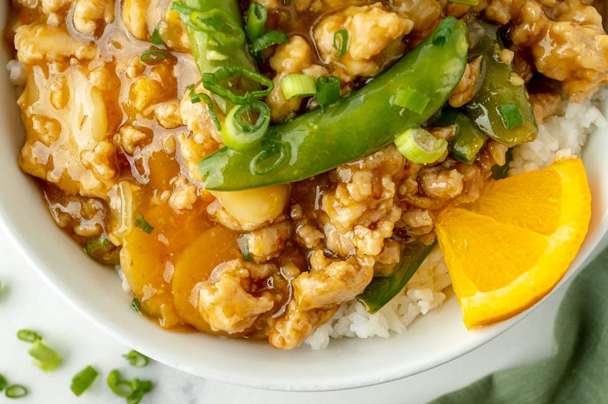 close up overhead shot of ground orange chicken bowl