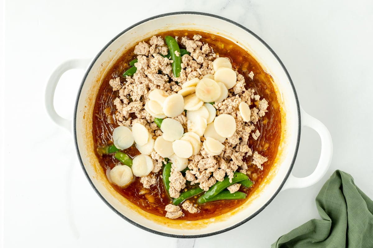 water chestnuts, ground chicken and sauce in pot