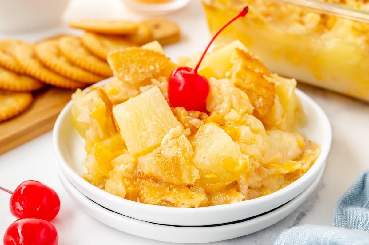 Pineapple casserole served on plate with golden cracker topping