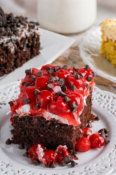 three slices of poke cake sitting on a table